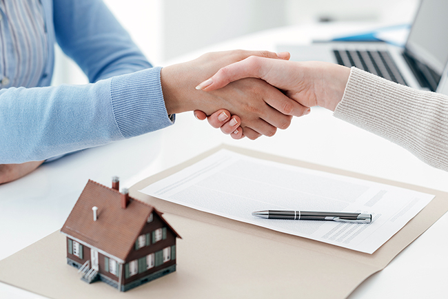 Australian mortgage broker reviewing files with an offshore assistant to ensure compliant loan processing.